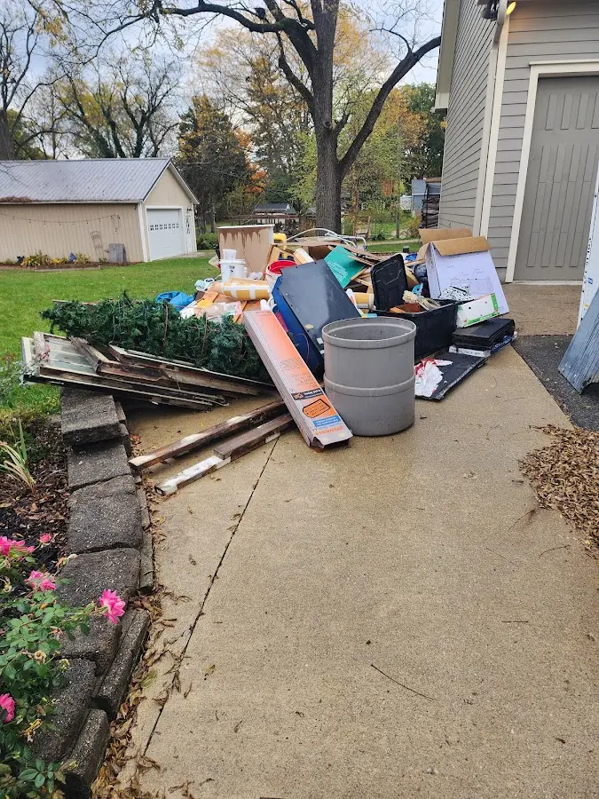 Dumpster being loaded with debris for Commercial Dumpster Rental in Windsor Heights